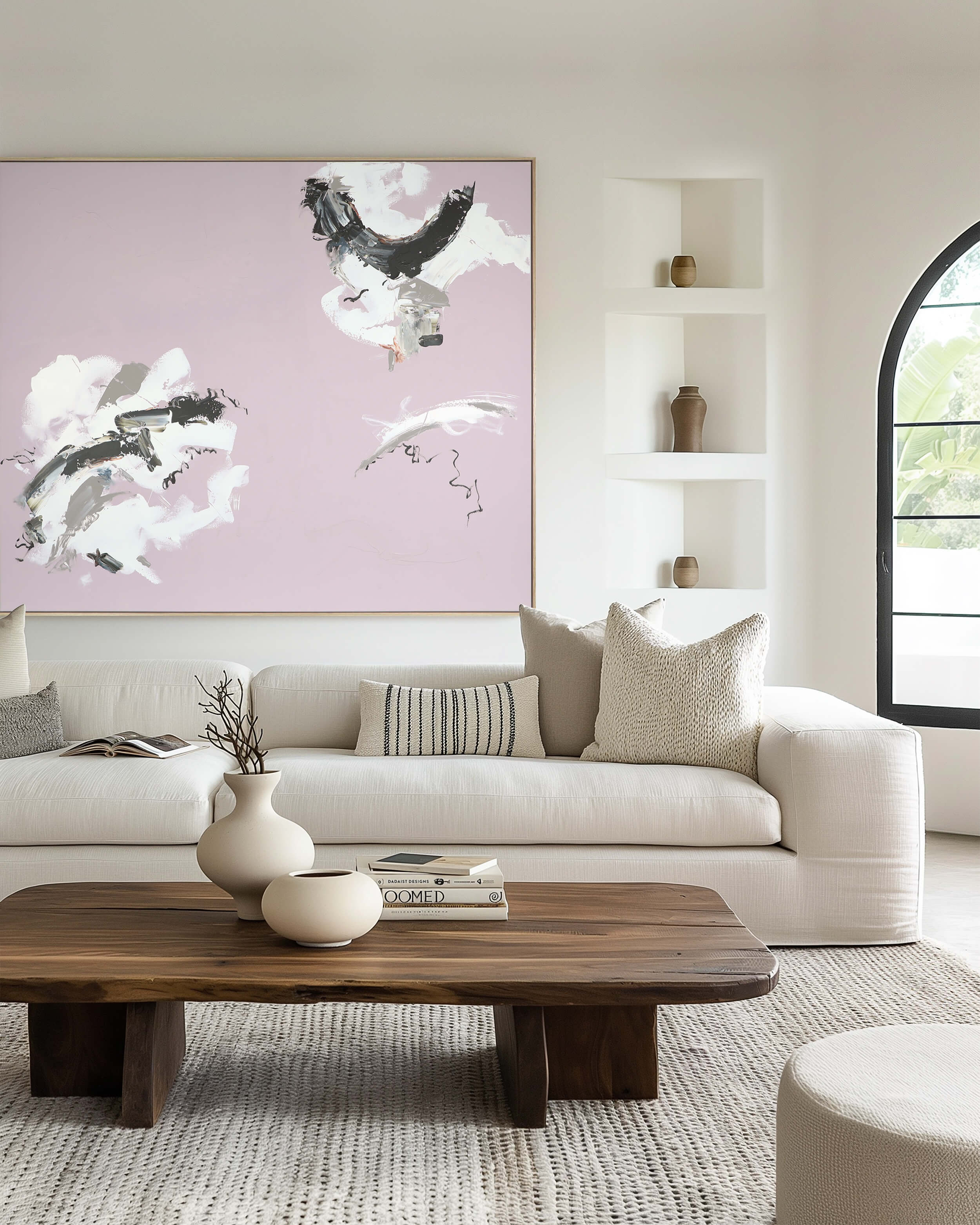 A large, pink abstract painting by Lee J Morgan displayed on a living room wall