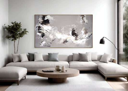 A  large, neutral abstract painting by Lee J Morgan displayed on a living room wall