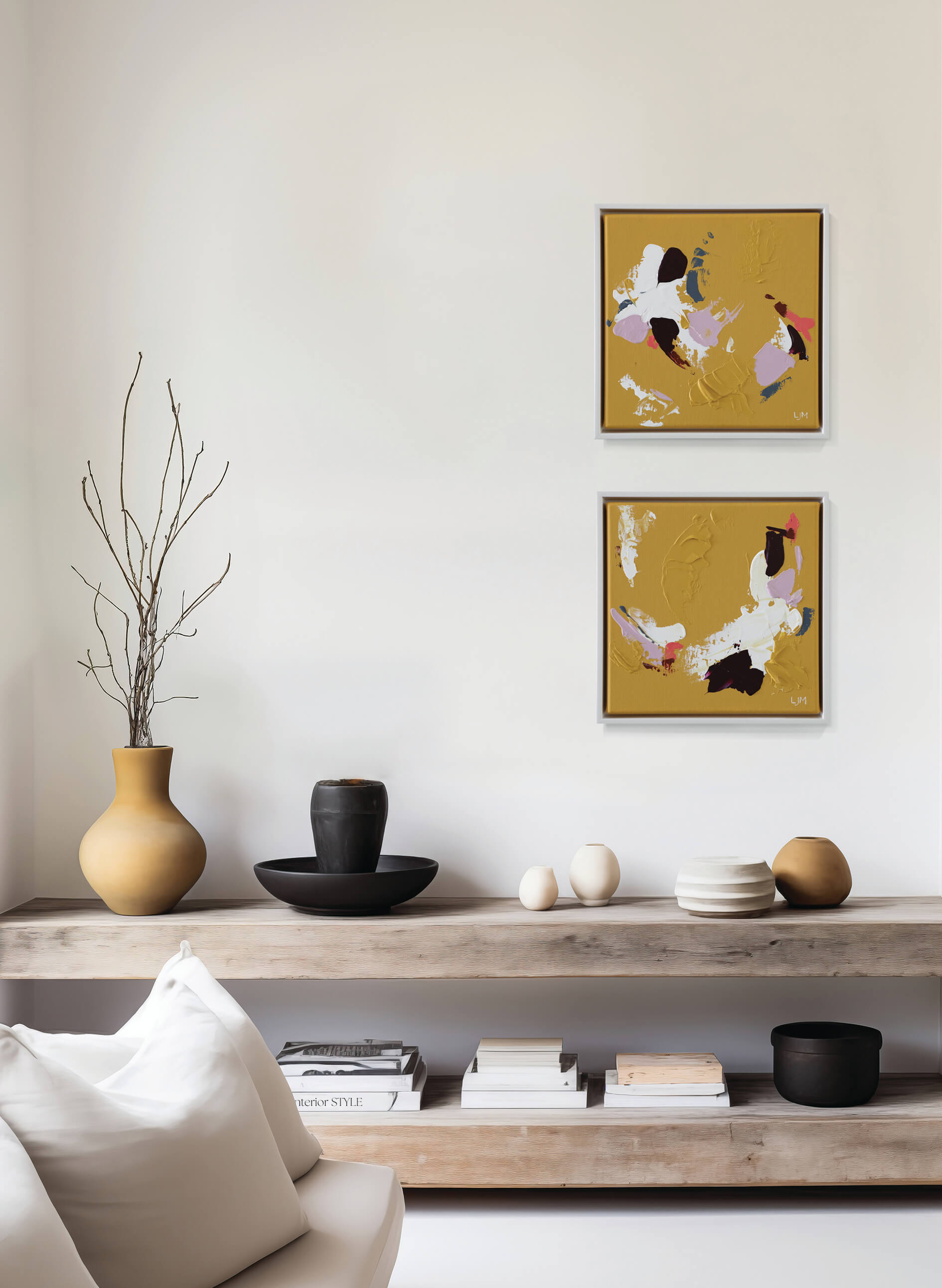 A small, yellow abstract painting by Lee J Morgan displayed on a living room wall