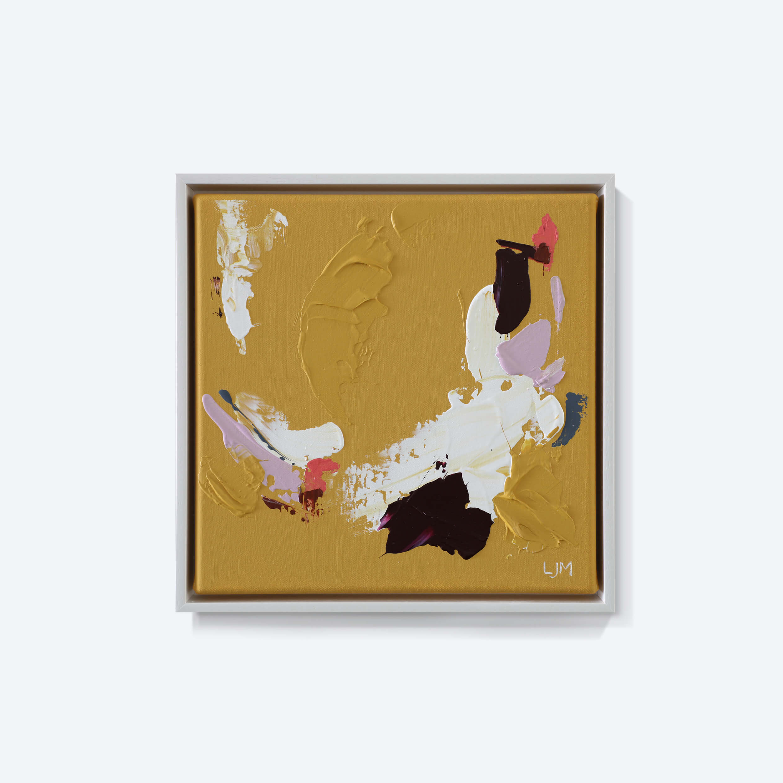 A small, neutral abstract painting by Lee J Morgan displayed on a living room wall