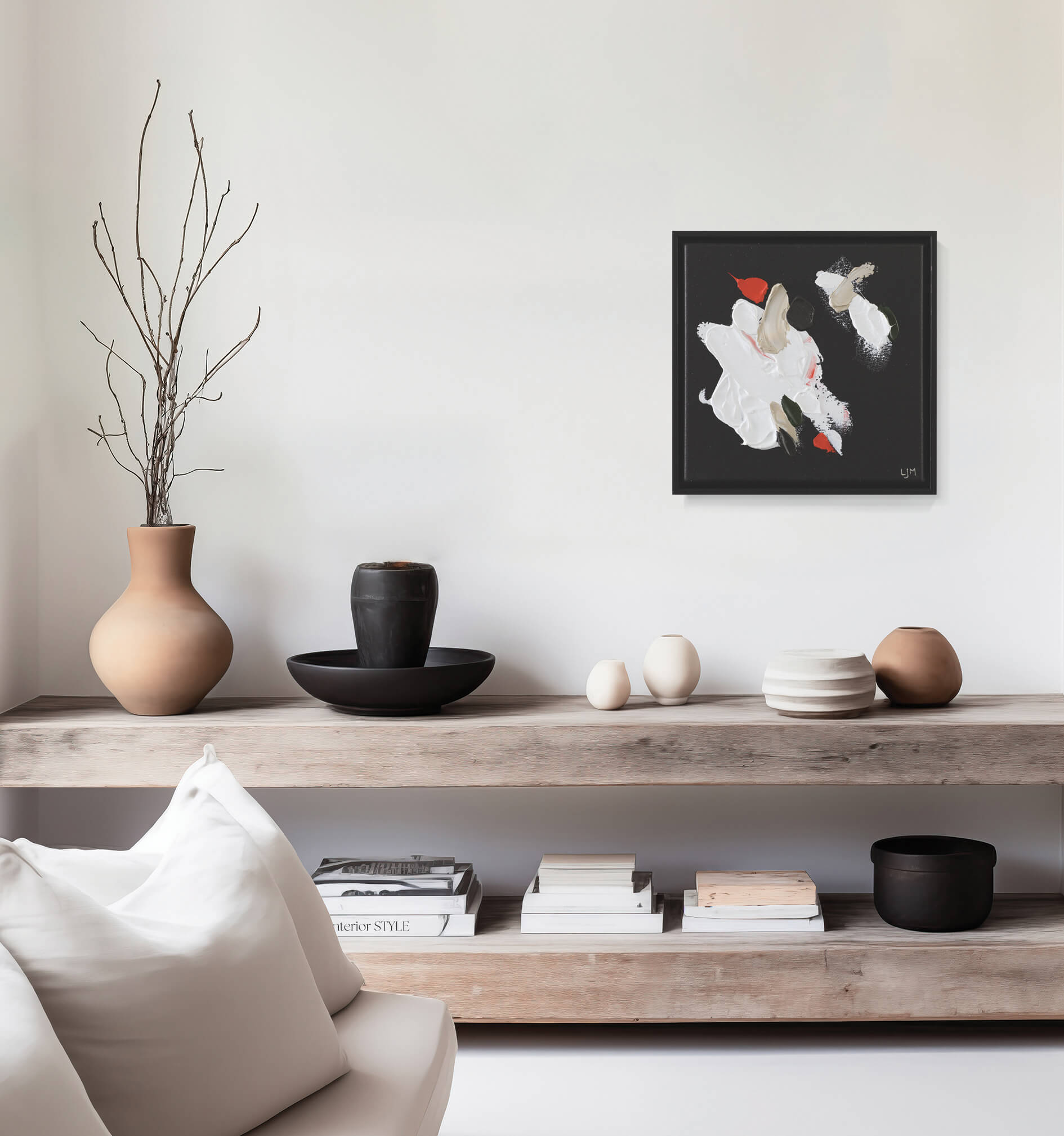 A small, dark abstract painting by Lee J Morgan displayed on a living room wall