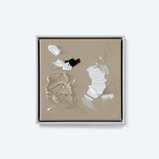 A small, neutral abstract painting by Lee J Morgan displayed on a living room wall