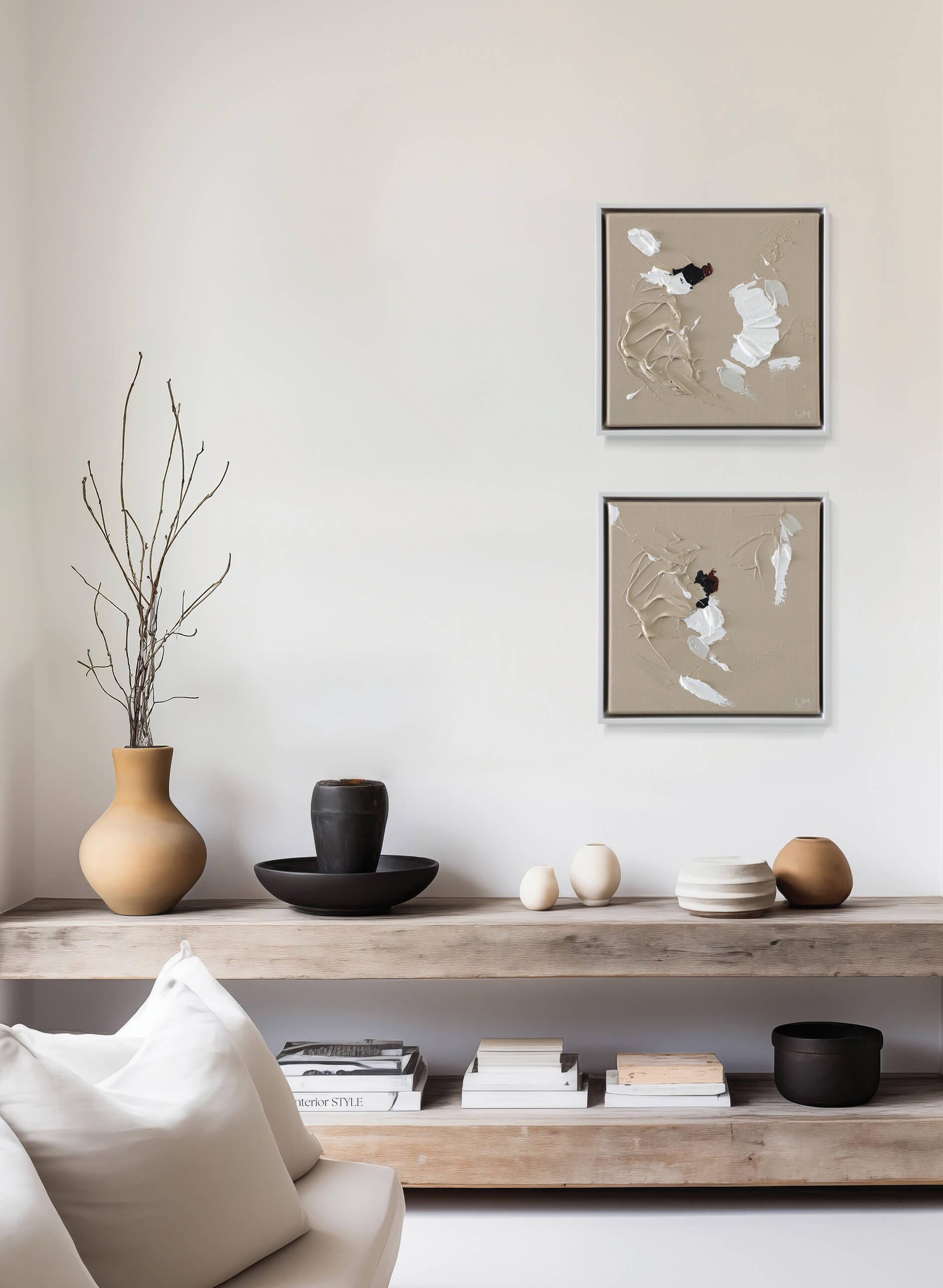 A small, neutral abstract painting by Lee J Morgan displayed on a living room wall