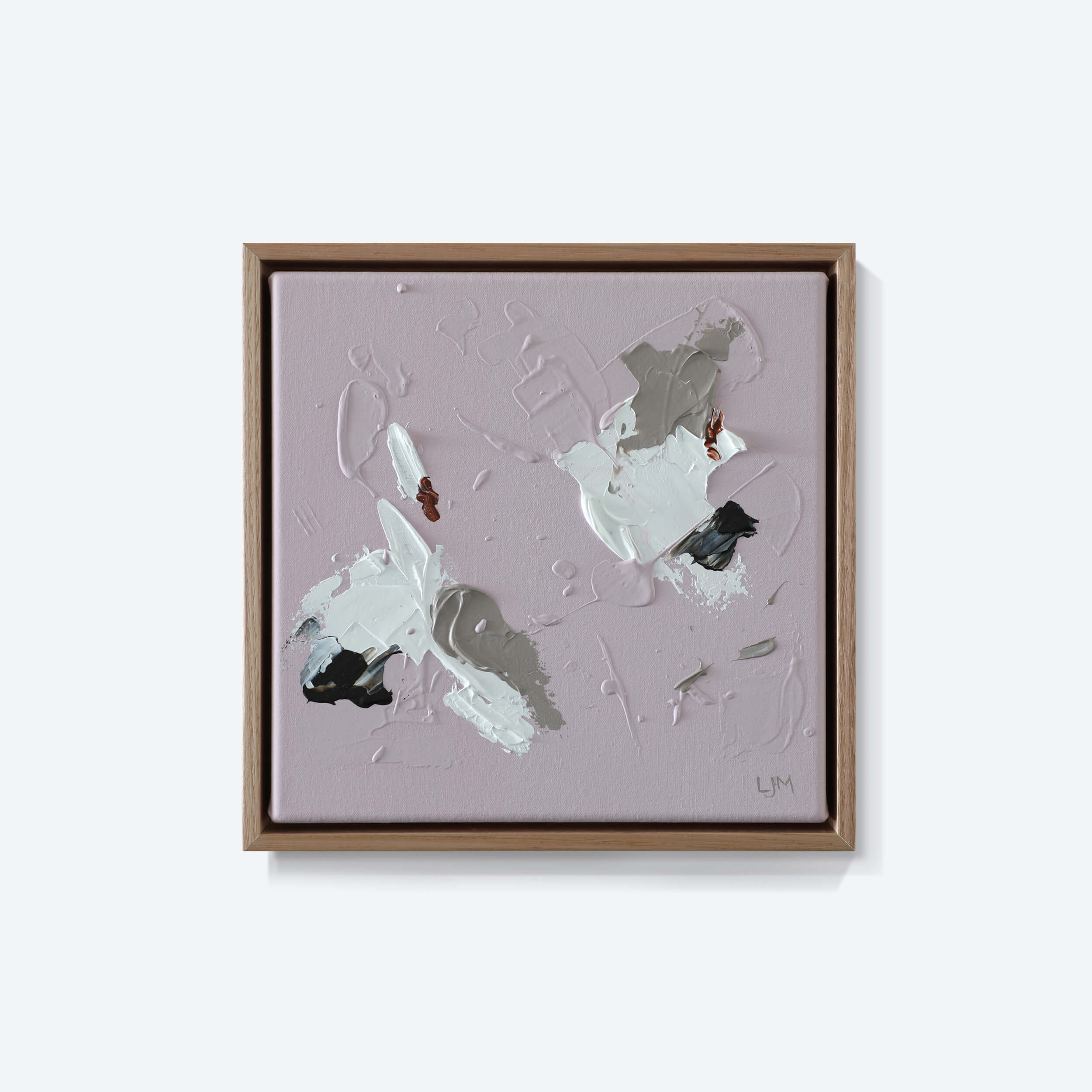 A small, pink abstract painting by Lee J Morgan Art displayed on a living room wall