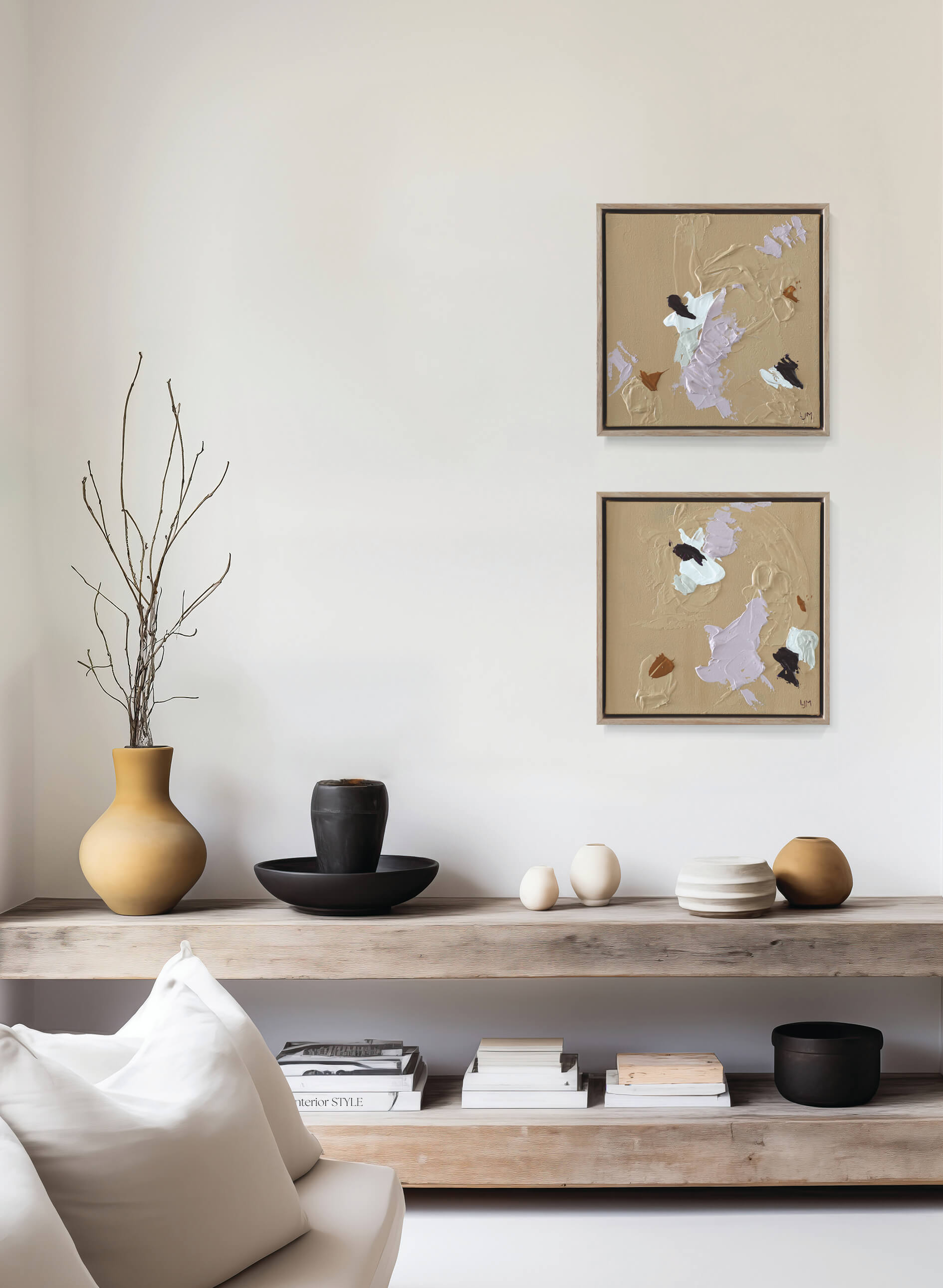 A small, neutral abstract painting by Lee J Morgan displayed on a living room wall