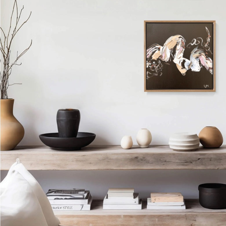 A small brown original abstract art by Lee J Morgan displayed on a living room wall