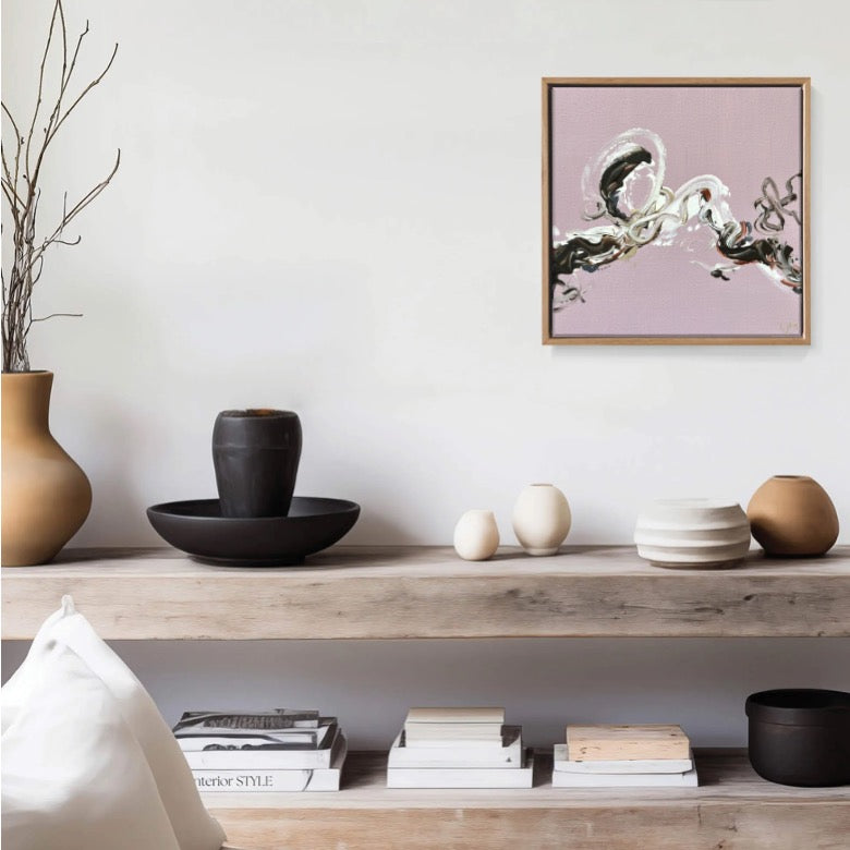 A small pink abstract art by Lee J Morgan displayed on a living room wall