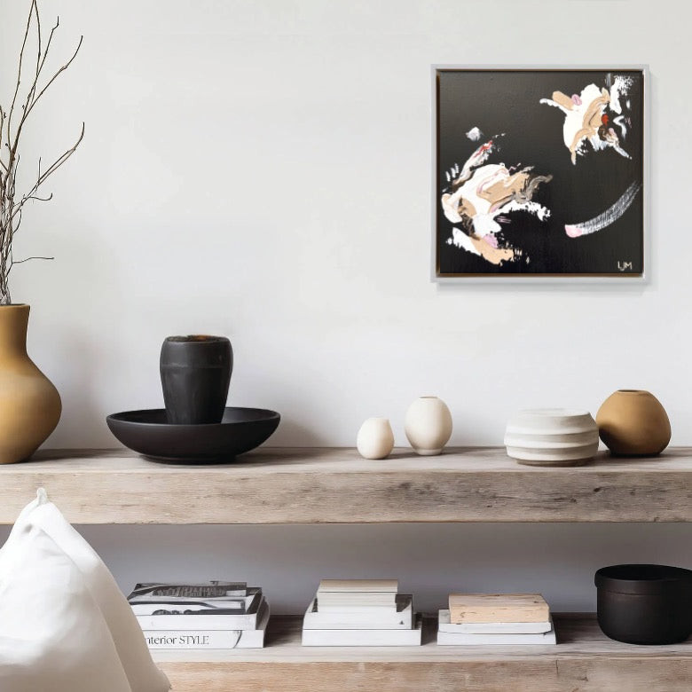 A small black artwork by Lee J Morgan Art displayed on a living room wall