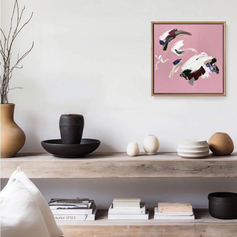 A small pink artwork by Lee J Morgan Art displayed on a living room wall