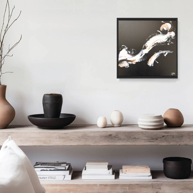 A small black artwork by Lee J Morgan Art displayed on a living room wall