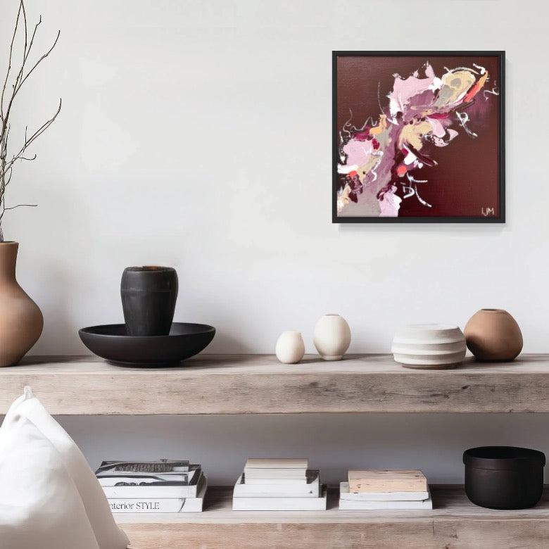 A small burgundy artwork by Lee J Morgan Art displayed on a living room wall